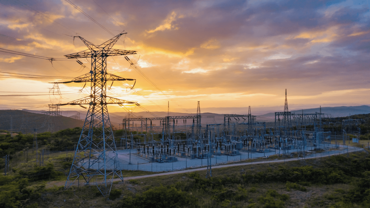 A complex and interconnected electrical grid, with power lines, substations, and transmission towers spanning across a diverse landscape, illustrating the flow of energy from generation to consumption, rendered in.png