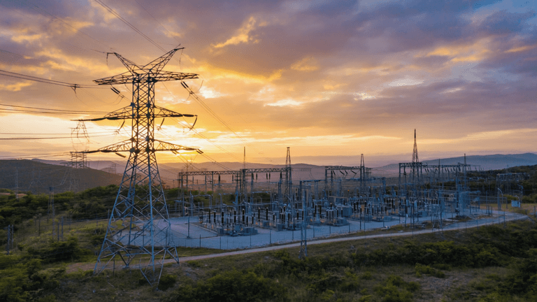 A complex and interconnected electrical grid, with power lines, substations, and transmission towers spanning across a diverse landscape, illustrating the flow of energy from generation to consumption, rendered in.png